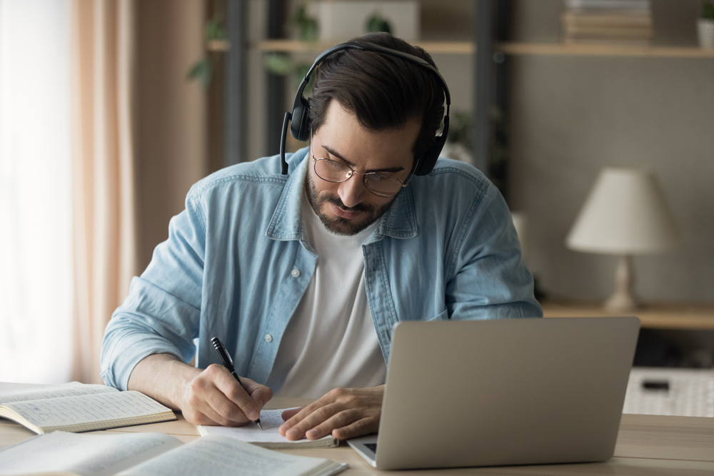 Young,Guy,In,Modern,Headset,Study,From,Home,Using,Laptop